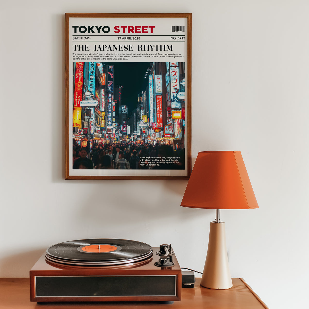 Tokyo street neon newspaper print in a walnut frame above a sideboard with a record player