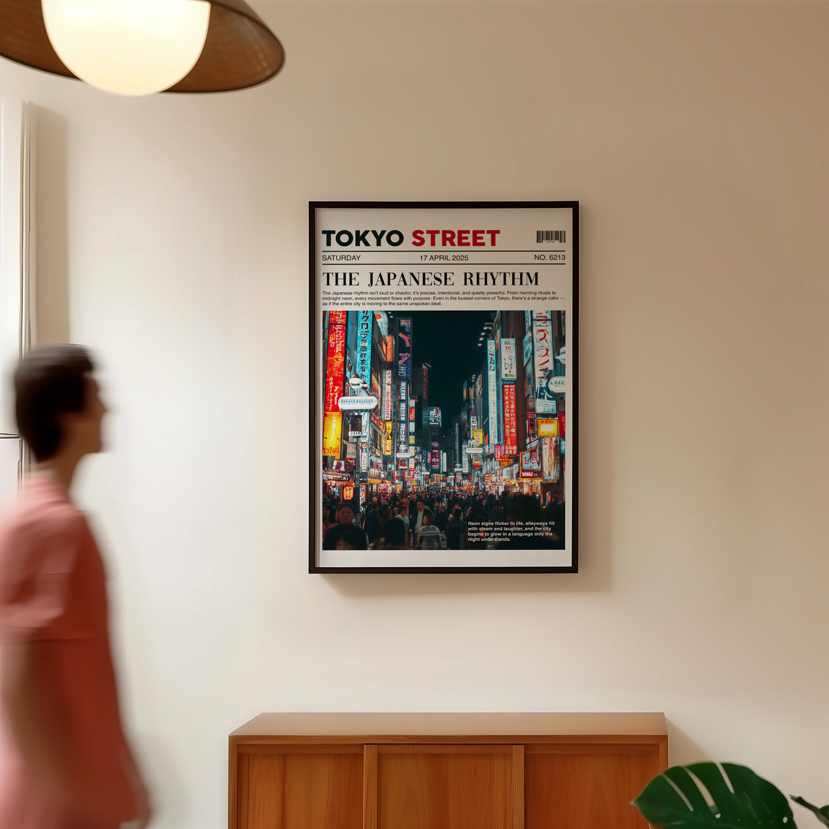 Tokyo street neon newspaper print in a black frame in a hallway under a rattan pendant