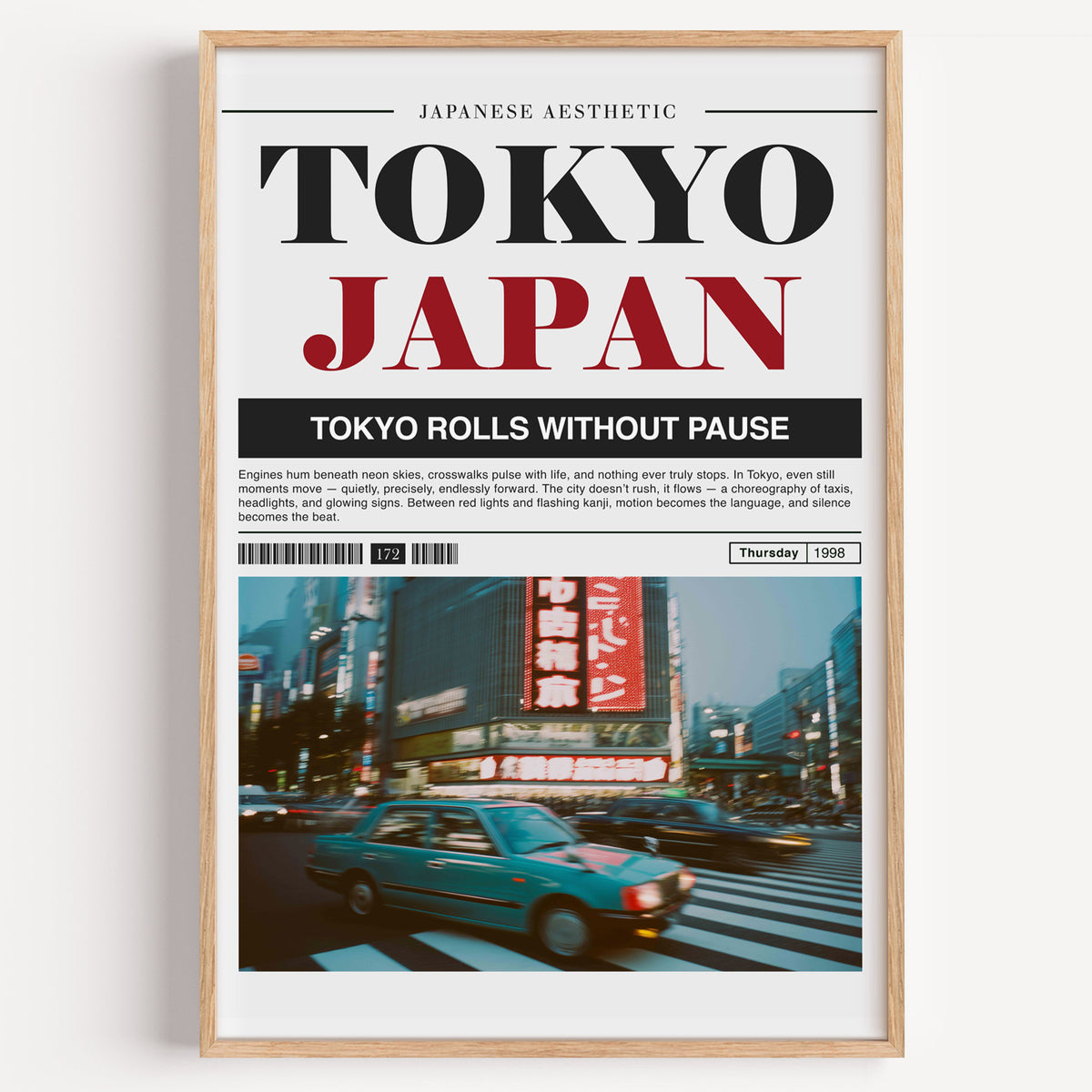 Tokyo taxi magazine layout print in a light oak frame on a plain white wall