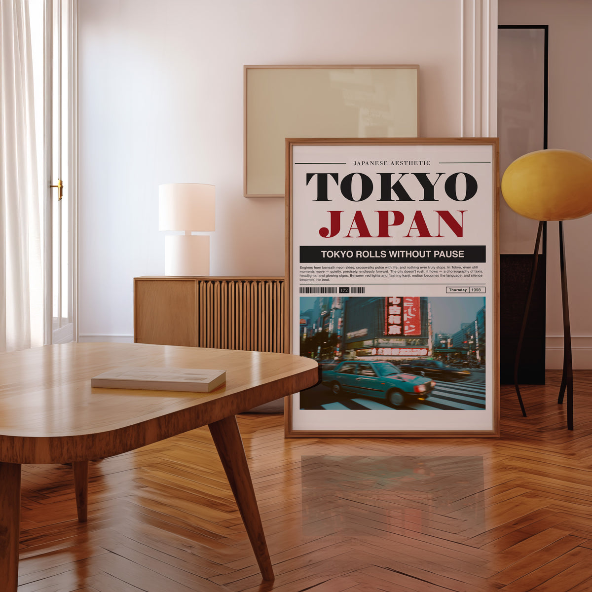 Tokyo taxi magazine layout print in a walnut frame leaning in a mid-century living room