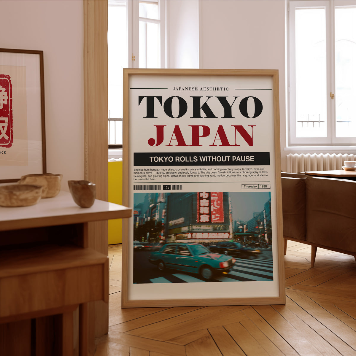 Tokyo taxi magazine layout print in an oak frame on the parquet floor of a sunlit living room