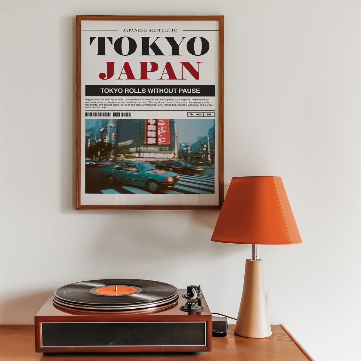 Tokyo taxi magazine layout print in a walnut frame above a sideboard with a record player