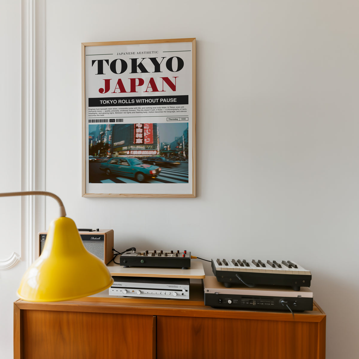 Tokyo taxi magazine layout print in an oak frame above a teak sideboard with vintage hi-fi