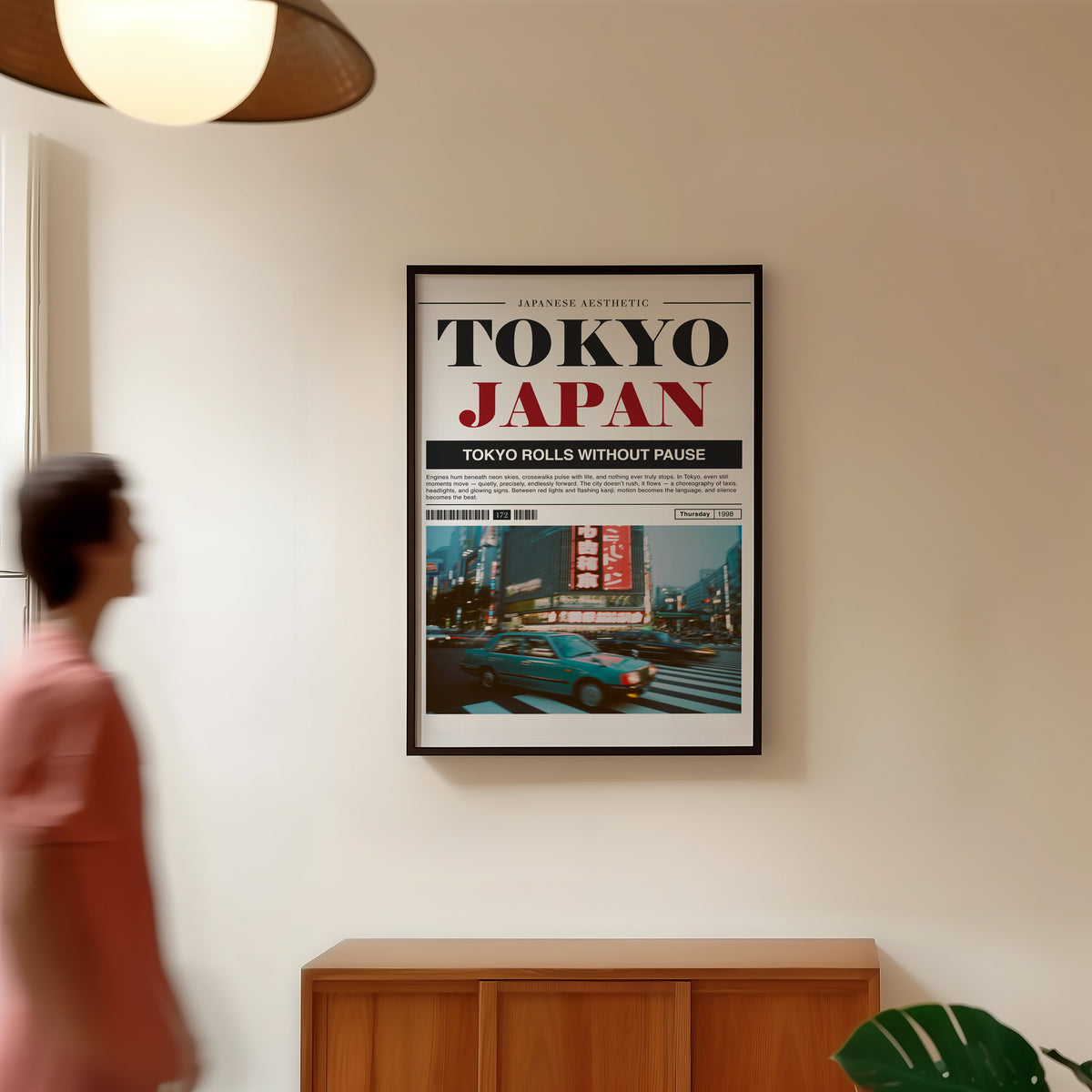 Tokyo taxi magazine layout print in a black frame in a hallway under a rattan pendant