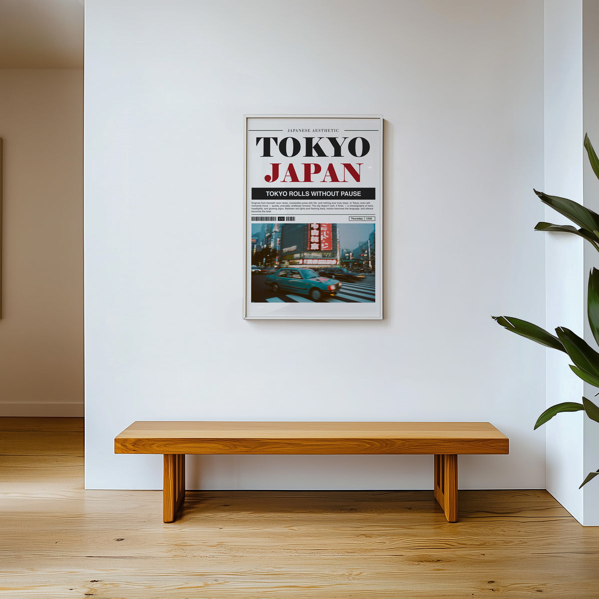 Tokyo taxi magazine layout print shown in a white frame above a wooden entryway bench