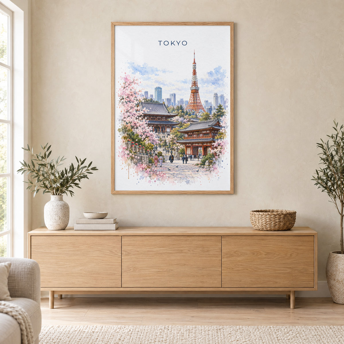 Tokyo watercolor print in an oak frame above a light wood sideboard in a Scandinavian living room