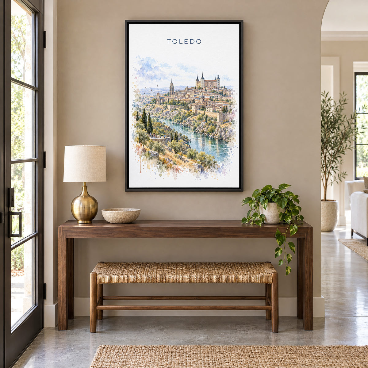 Toledo, Spain watercolor print as a black floater canvas above a walnut console and woven bench in an entryway