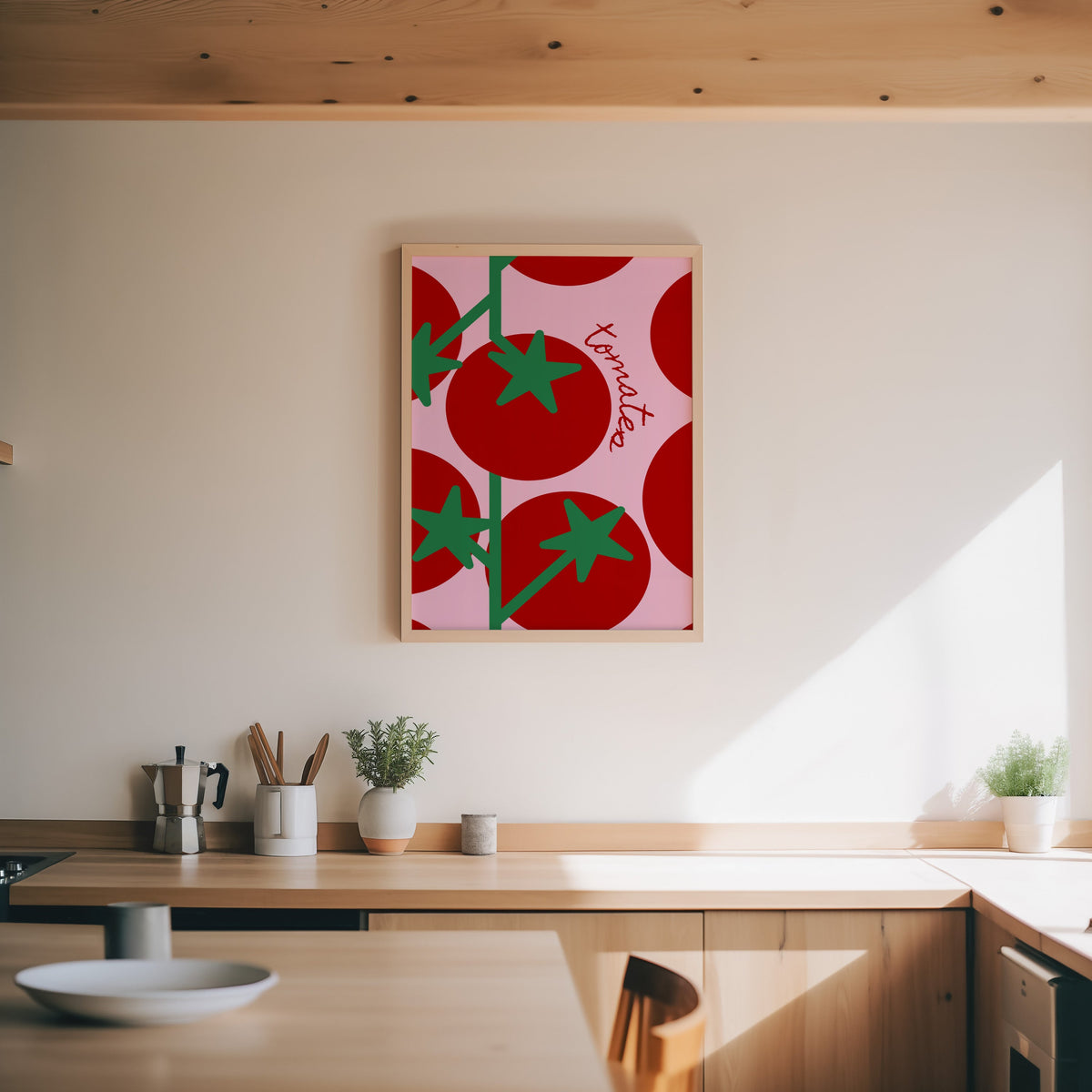 Tomates print in an oak frame above a wood counter with a moka pot and herbs