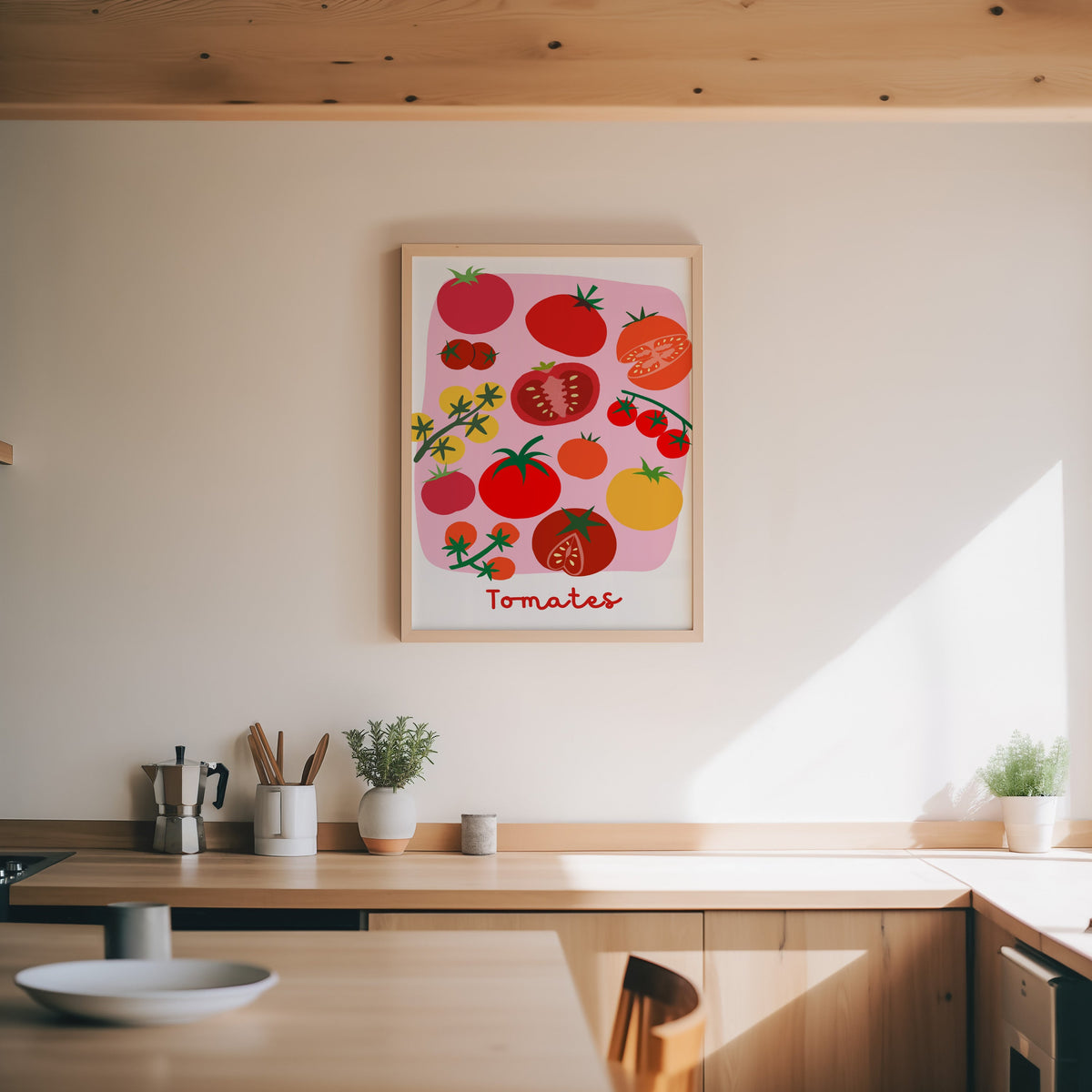 Tomates print in an oak frame above a wood counter with a moka pot and herbs