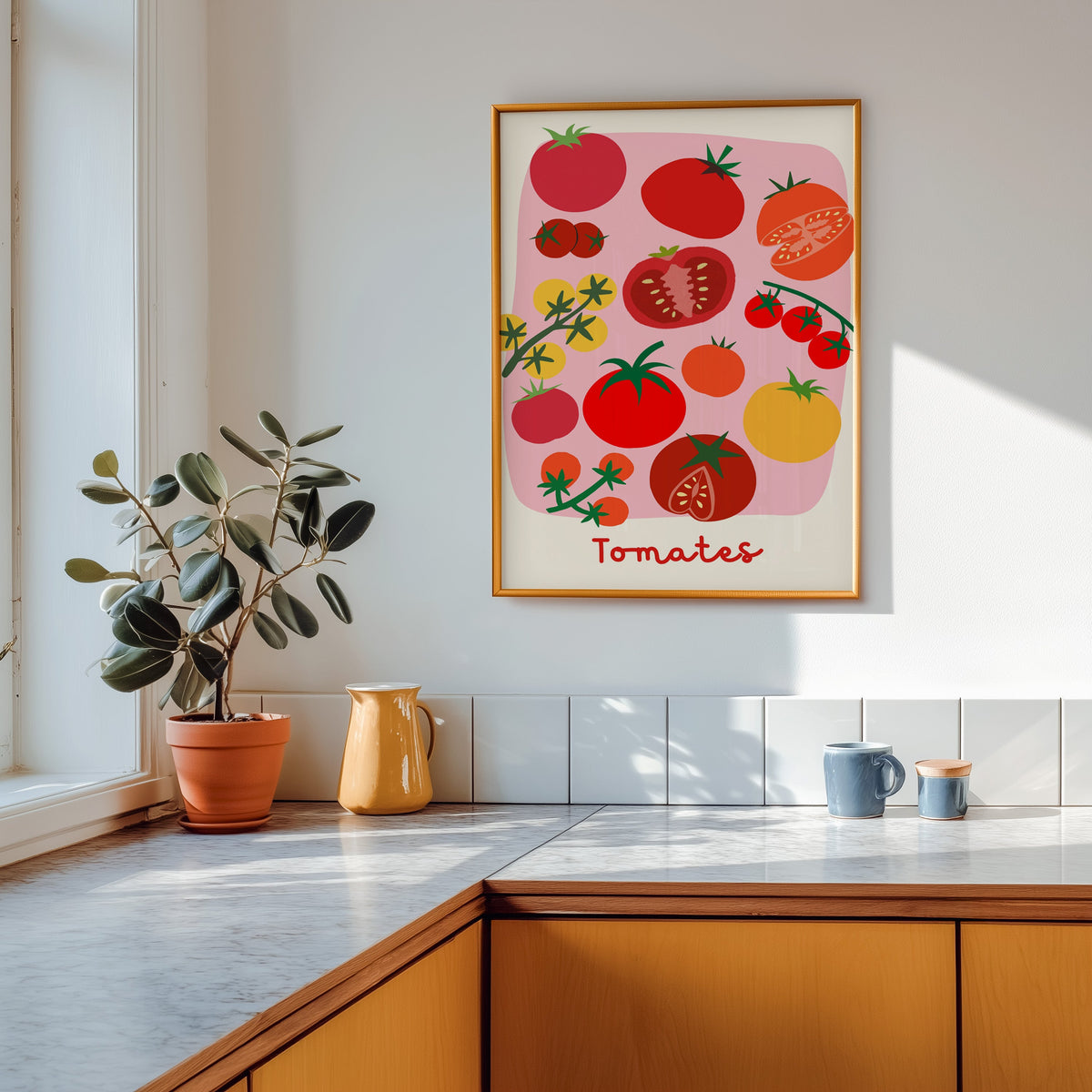 Tomates print shown in a gold frame above a marble counter with a yellow ceramic jug