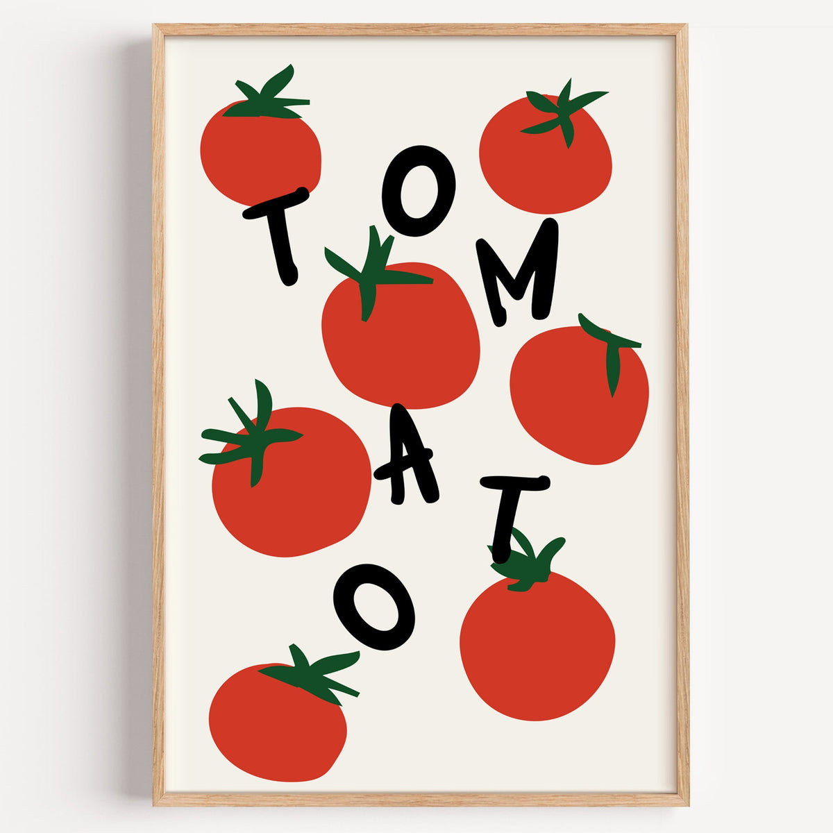 Tomato letters print in a light oak frame on a plain white wall