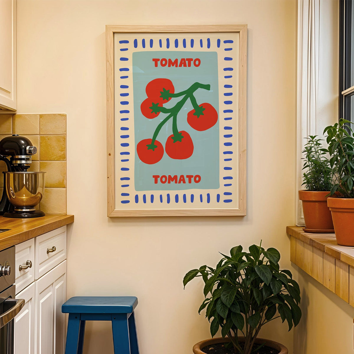 Tomato seed packet print in a wood frame on a yellow tiled kitchen wall