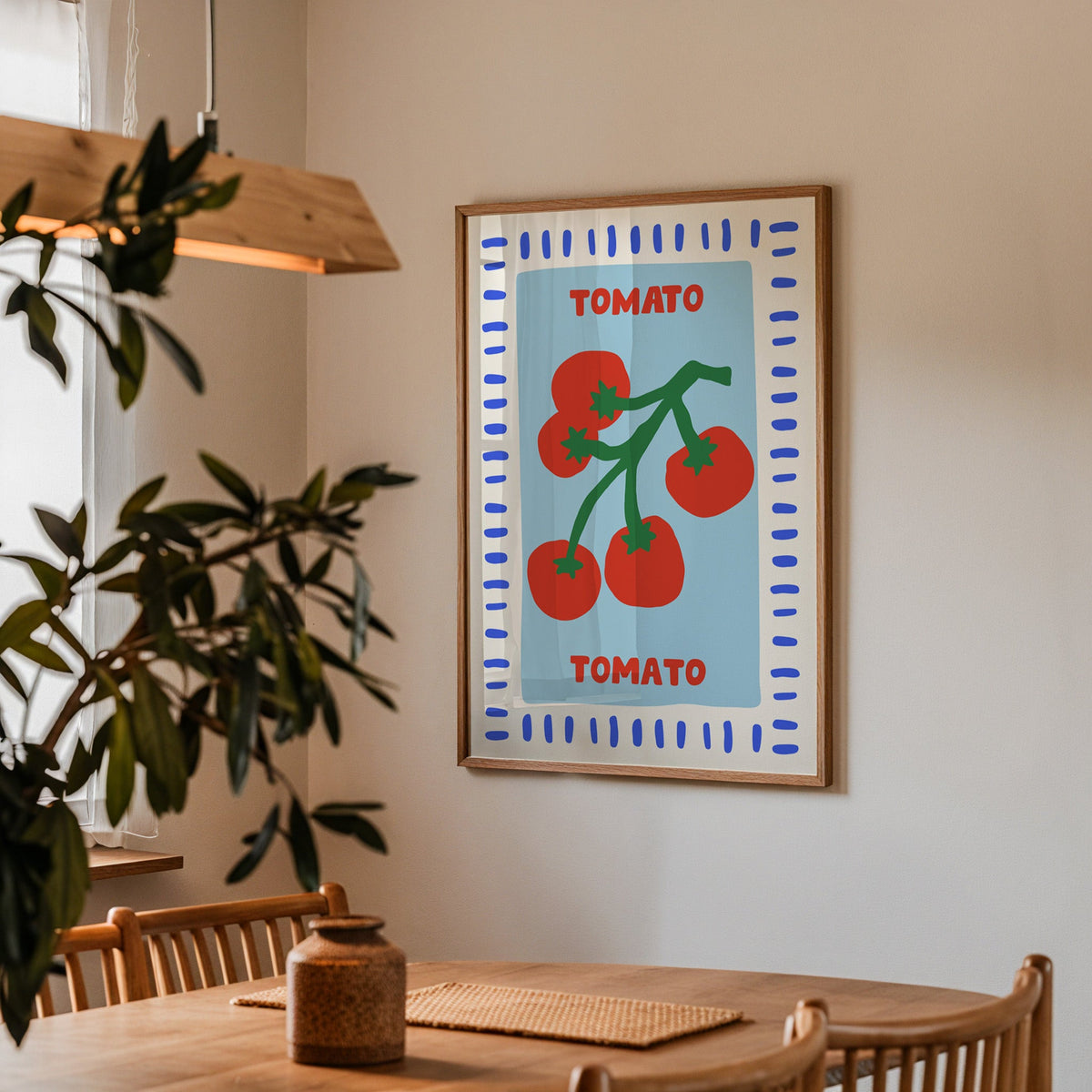 Tomato seed packet print in a walnut frame above a table beside an olive tree