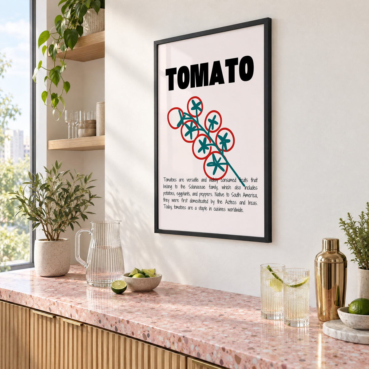 TOMATO bold type tomato vine print in a black frame above a pink terrazzo cocktail counter with limes, seen at an angle