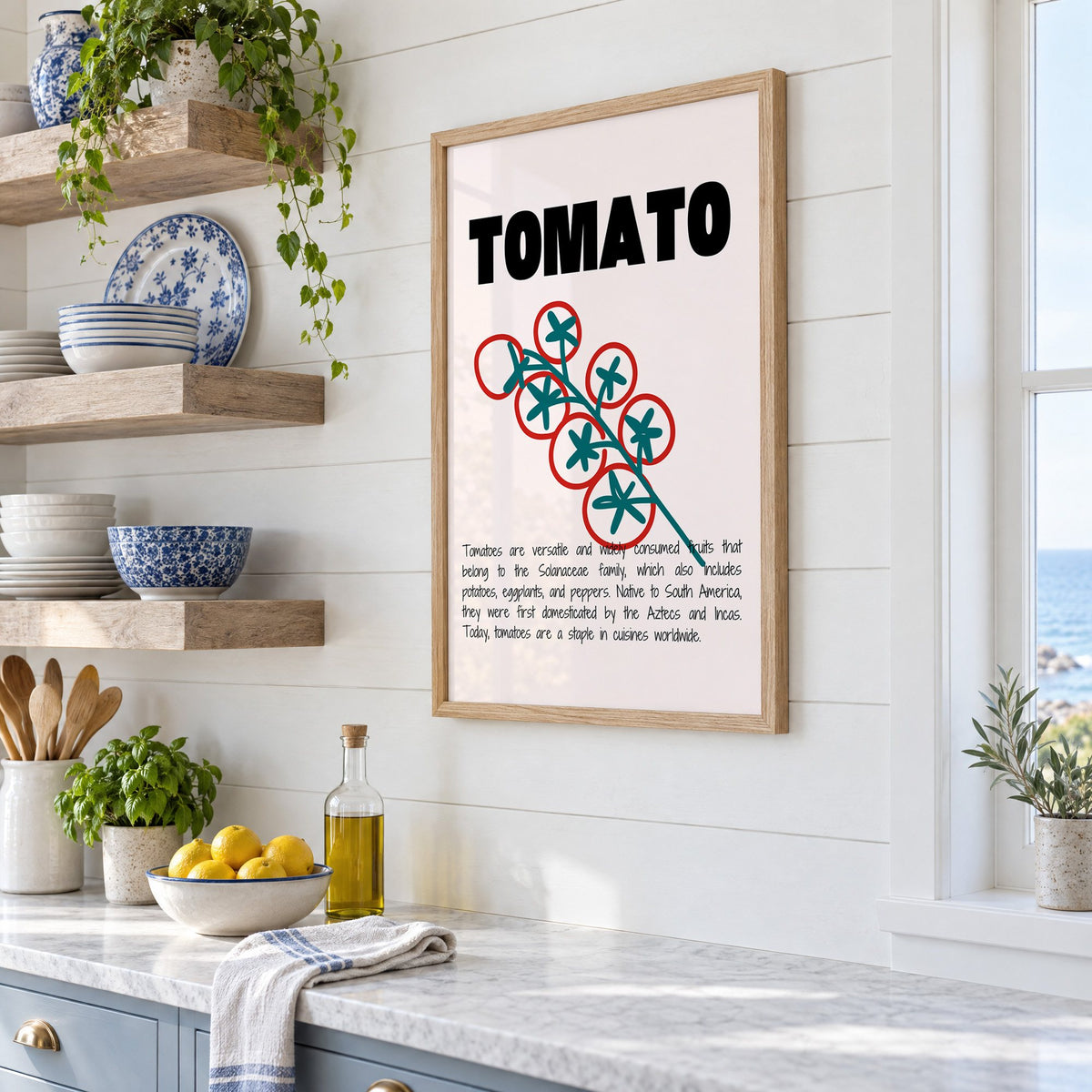 TOMATO bold type tomato vine print in an oak frame in a white coastal kitchen beside blue and white plates