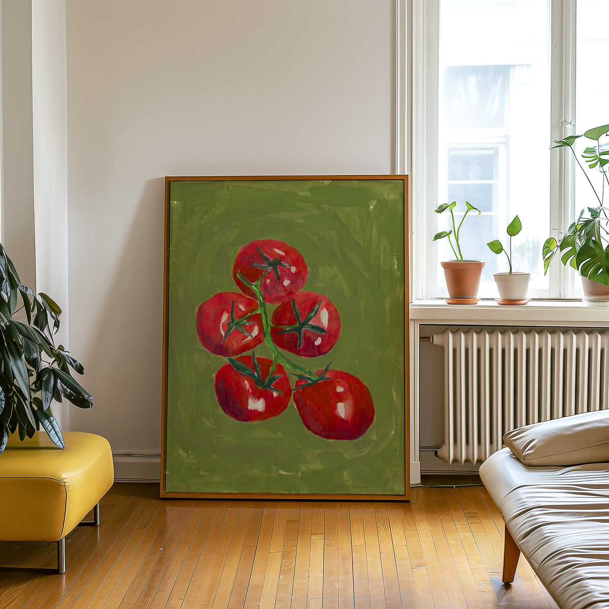 Olive green tomato print in an oak frame leaning beside a yellow leather bench