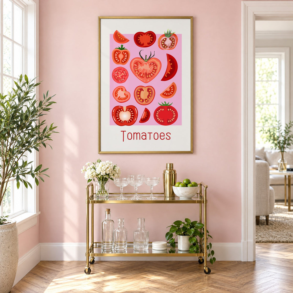 Tomatoes thin lettering pink panel tomato chart print in a brass frame on a blush pink wall above a gold bar cart with glassware