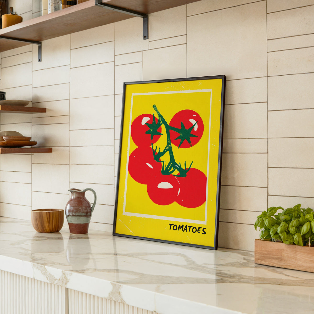 Tomatoes print in a black frame leaning on a marble counter in a tiled kitchen