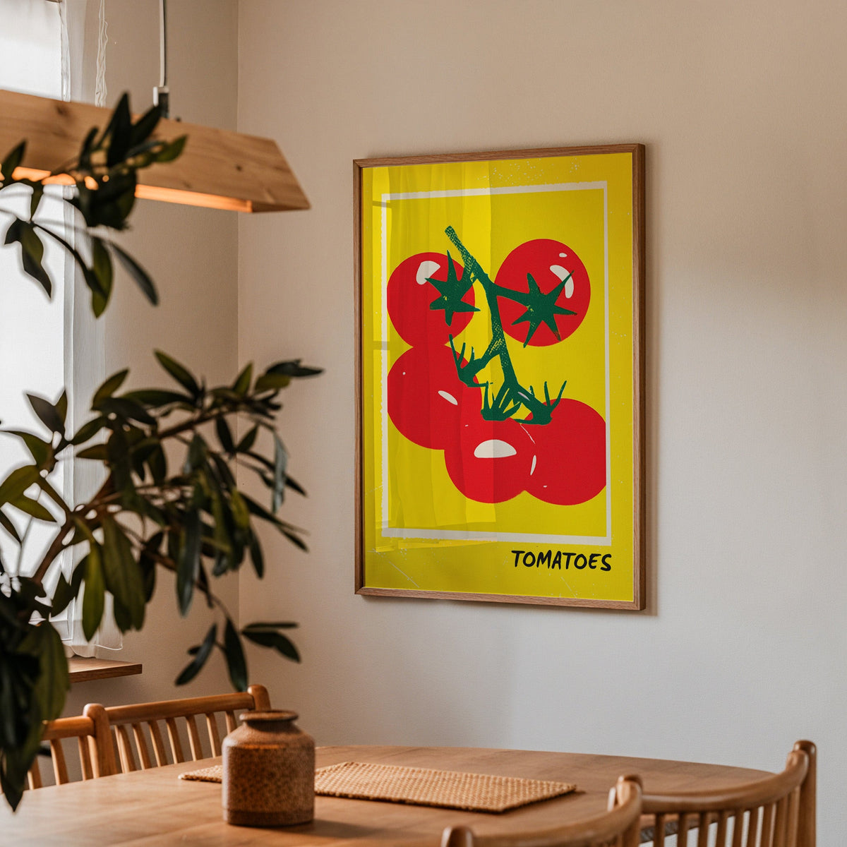 Tomatoes print in a walnut frame above a dining table with olive branches