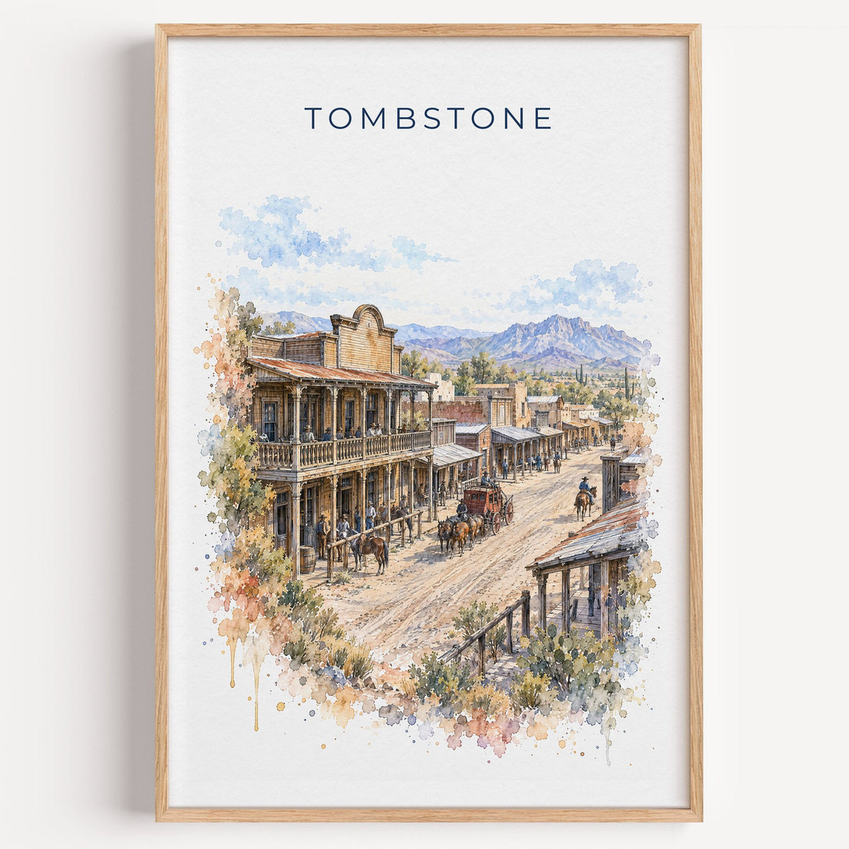 Tombstone, Arizona watercolor print in a light oak frame on a plain white wall