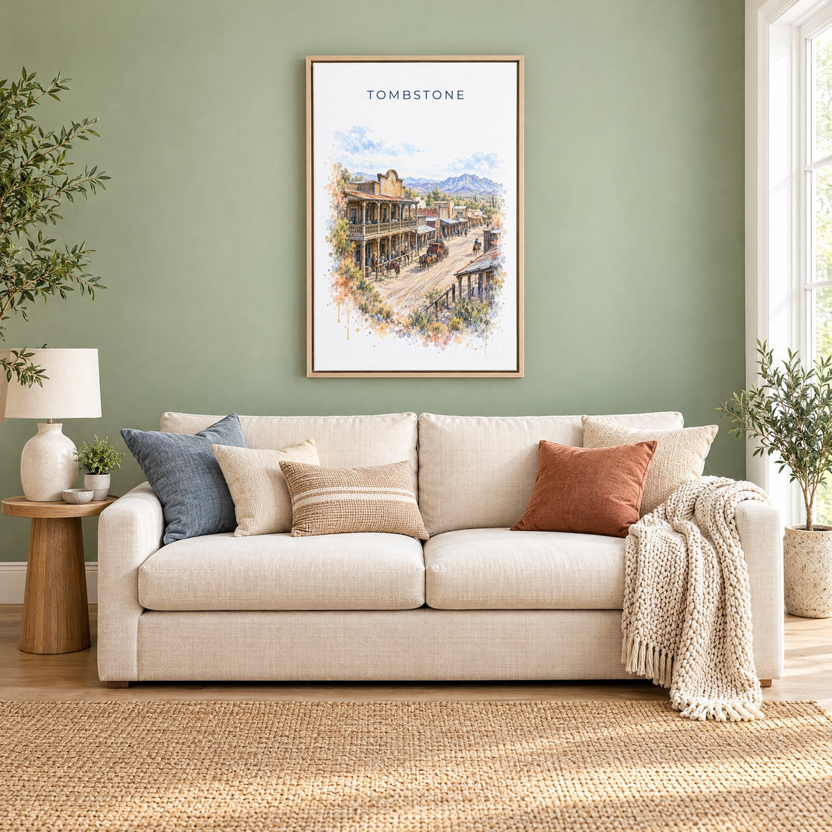 Tombstone, Arizona watercolor print as a natural floater canvas above a cream linen sofa on a sage green wall
