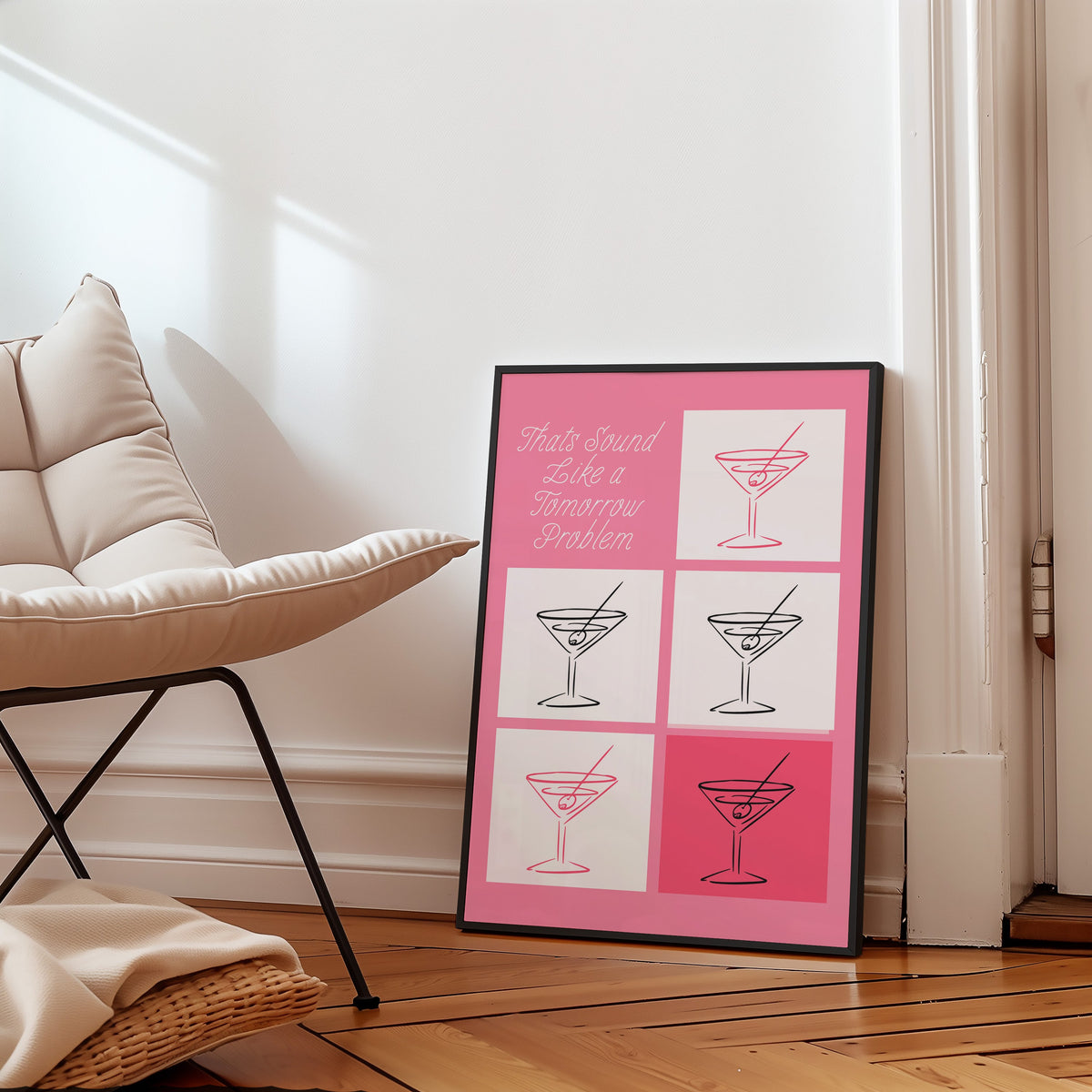 Tomorrow problem martini grid print in a slim black frame leaning on a herringbone floor beside a cream armchair