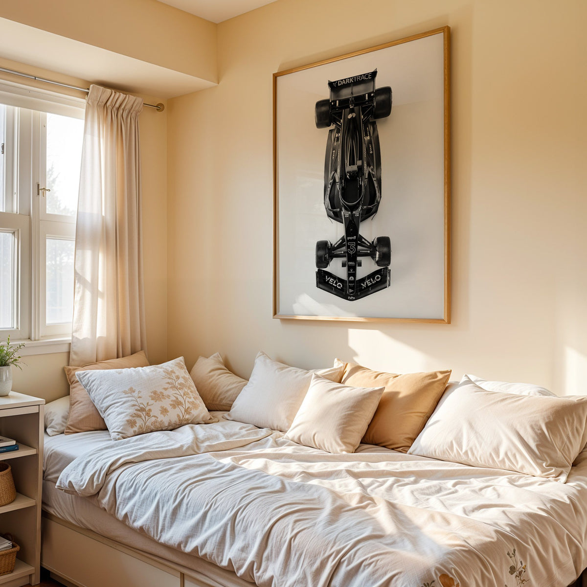 Top view black formula-style race car print in an oak frame above a cream daybed in a sunny bedroom