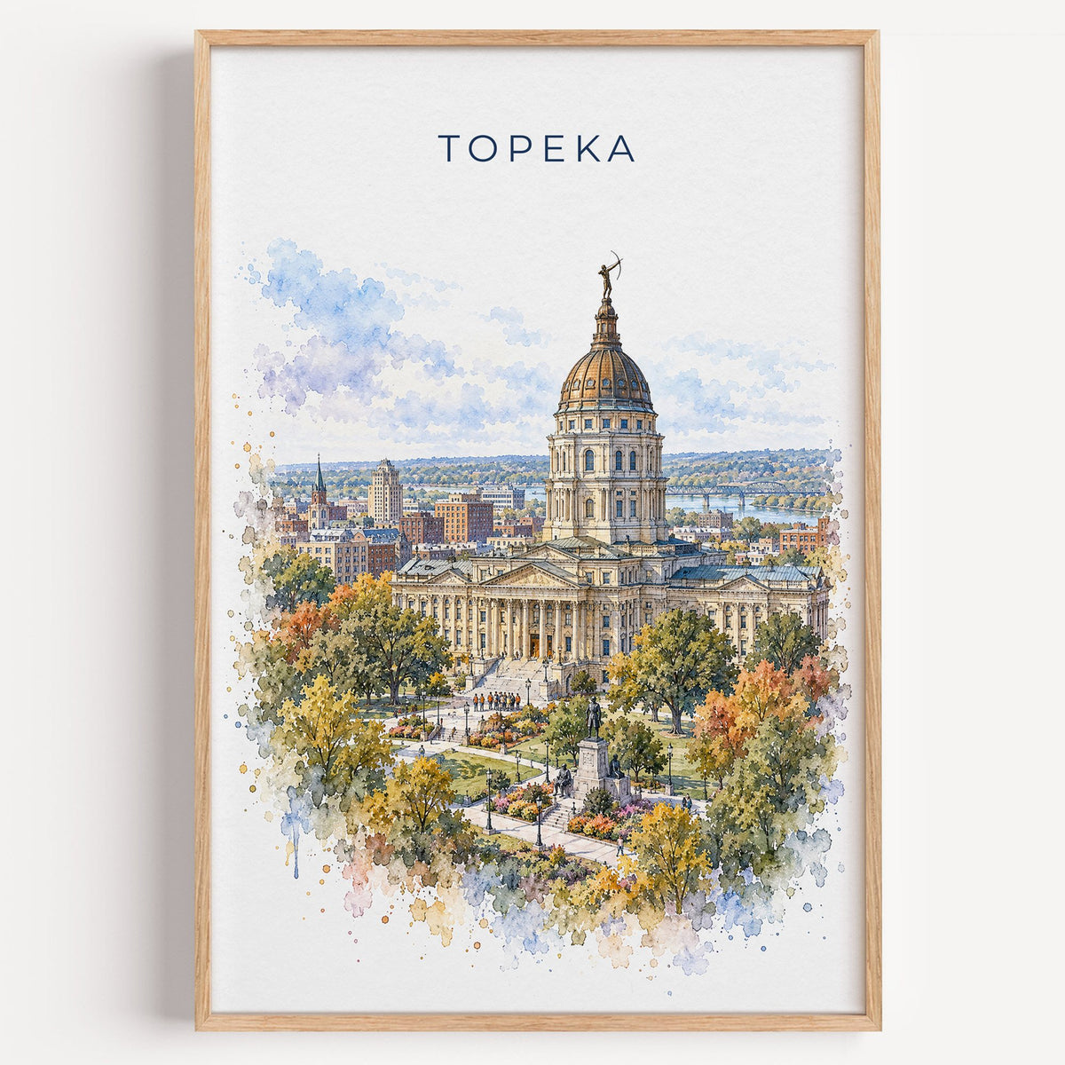 Topeka watercolor print in a light oak frame on a plain white wall