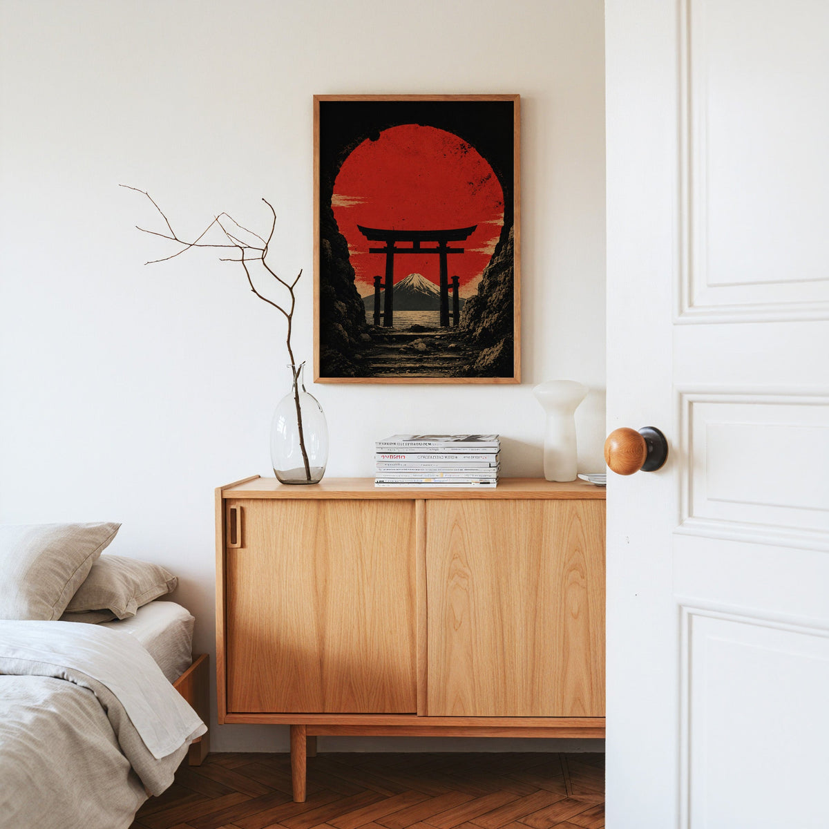 torii gate framing Mount Fuji and red sun print in an oak frame above an oak sideboard in a bedroom with linen bedding