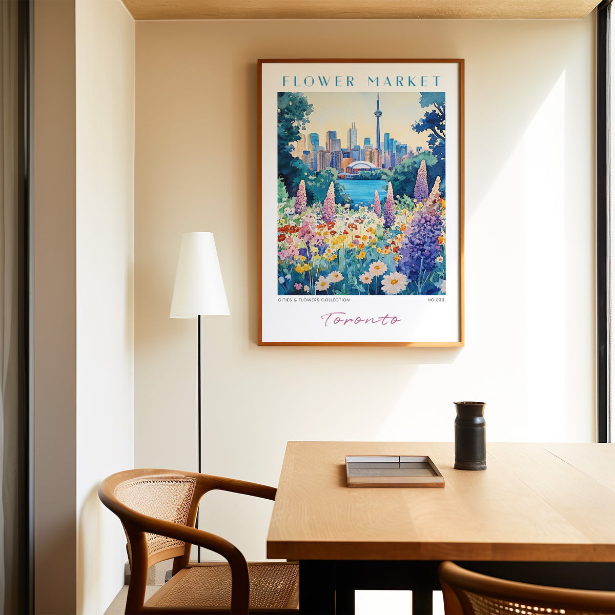 Toronto flower market print in an oak frame above a dining table and cane chair