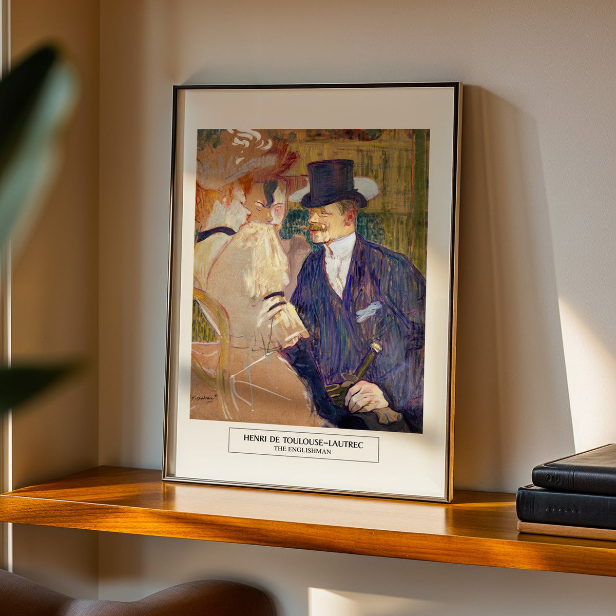 Montmartre nightlife print in a black frame on a walnut shelf in evening light
