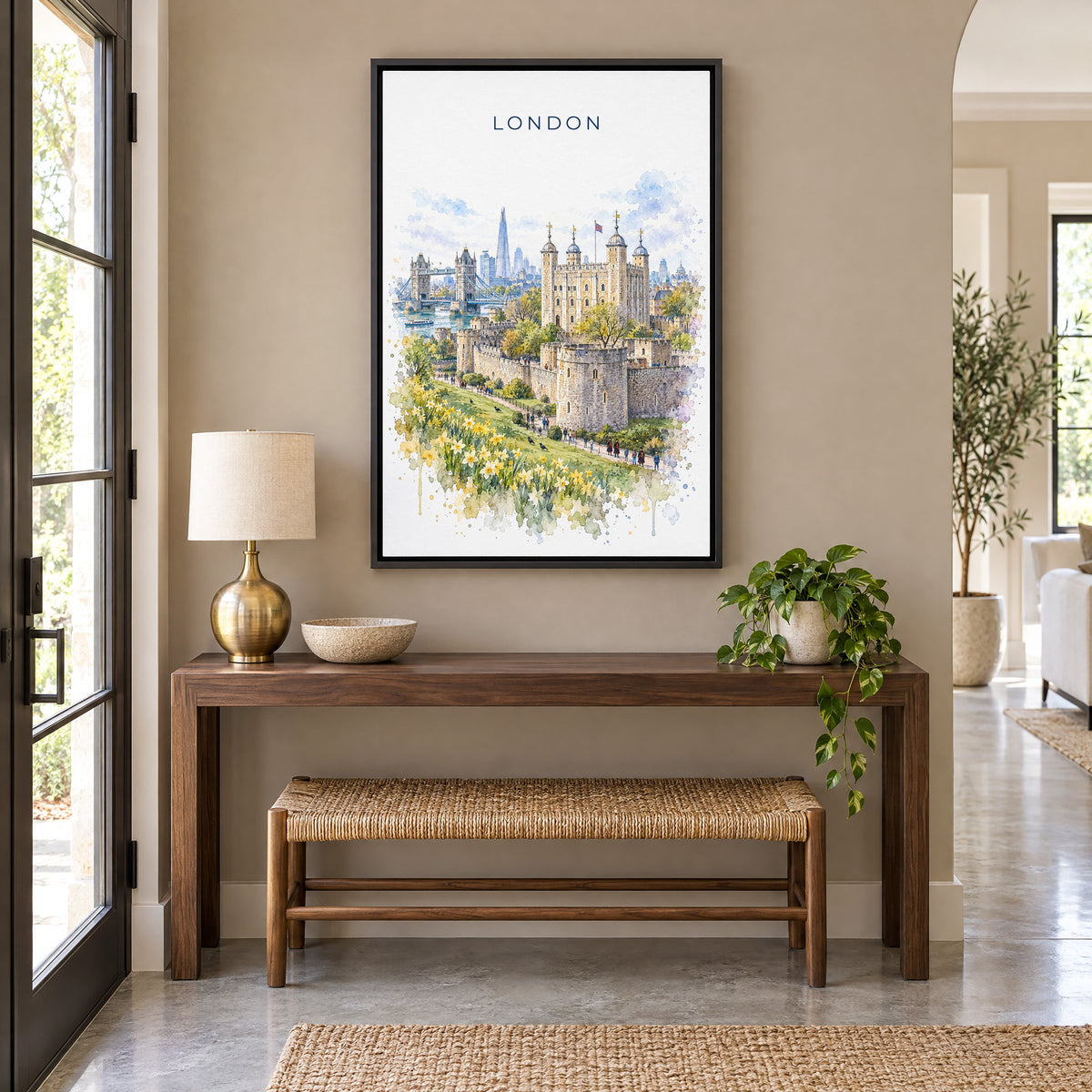 Tower of London watercolor print as a black floater canvas above a walnut console and woven bench in an entryway