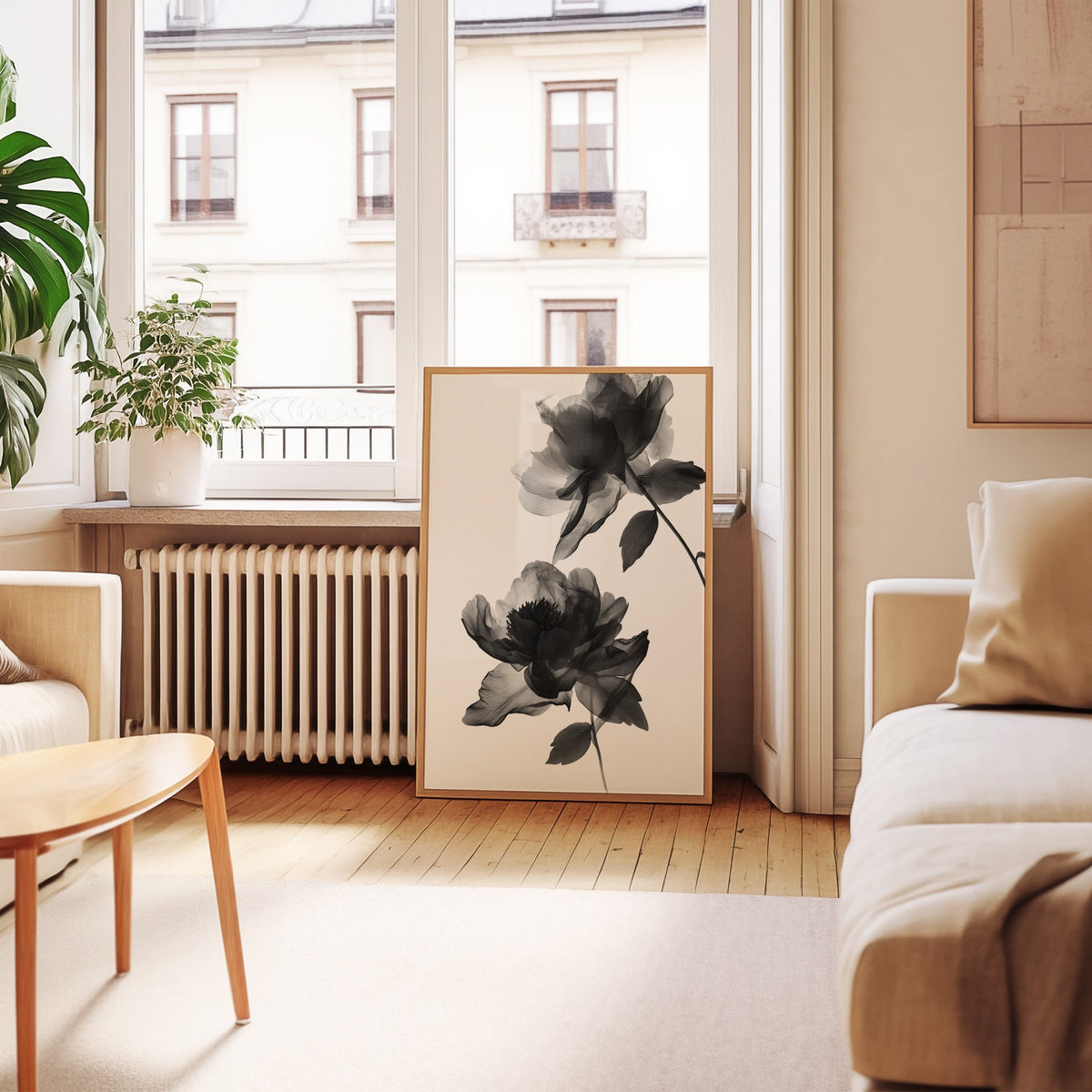 Two translucent X-ray flowers on white print in an oak frame leaning by a French window in a living room