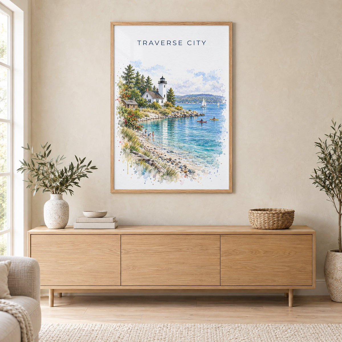 Traverse City watercolor print in an oak frame above a light wood sideboard in a Scandinavian living room