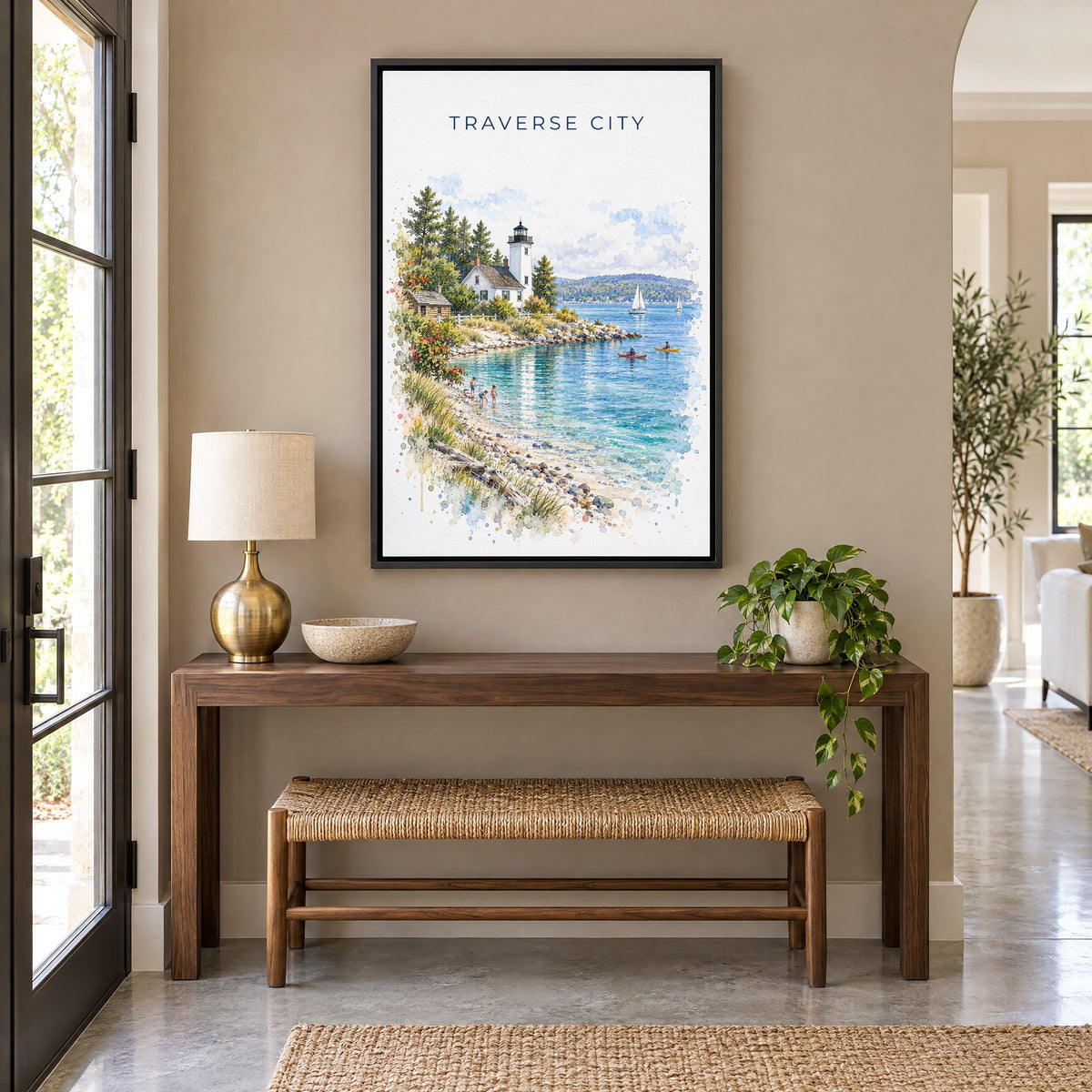 Traverse City watercolor print as a black floater canvas above a walnut console and woven bench in an entryway