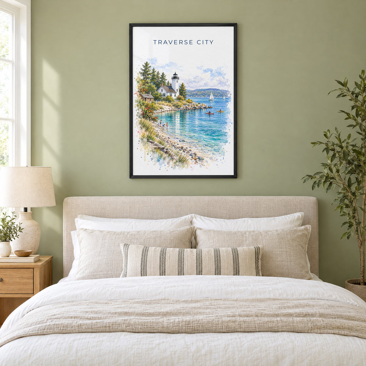 Traverse City watercolor print in a black frame above an upholstered headboard in a sage green bedroom