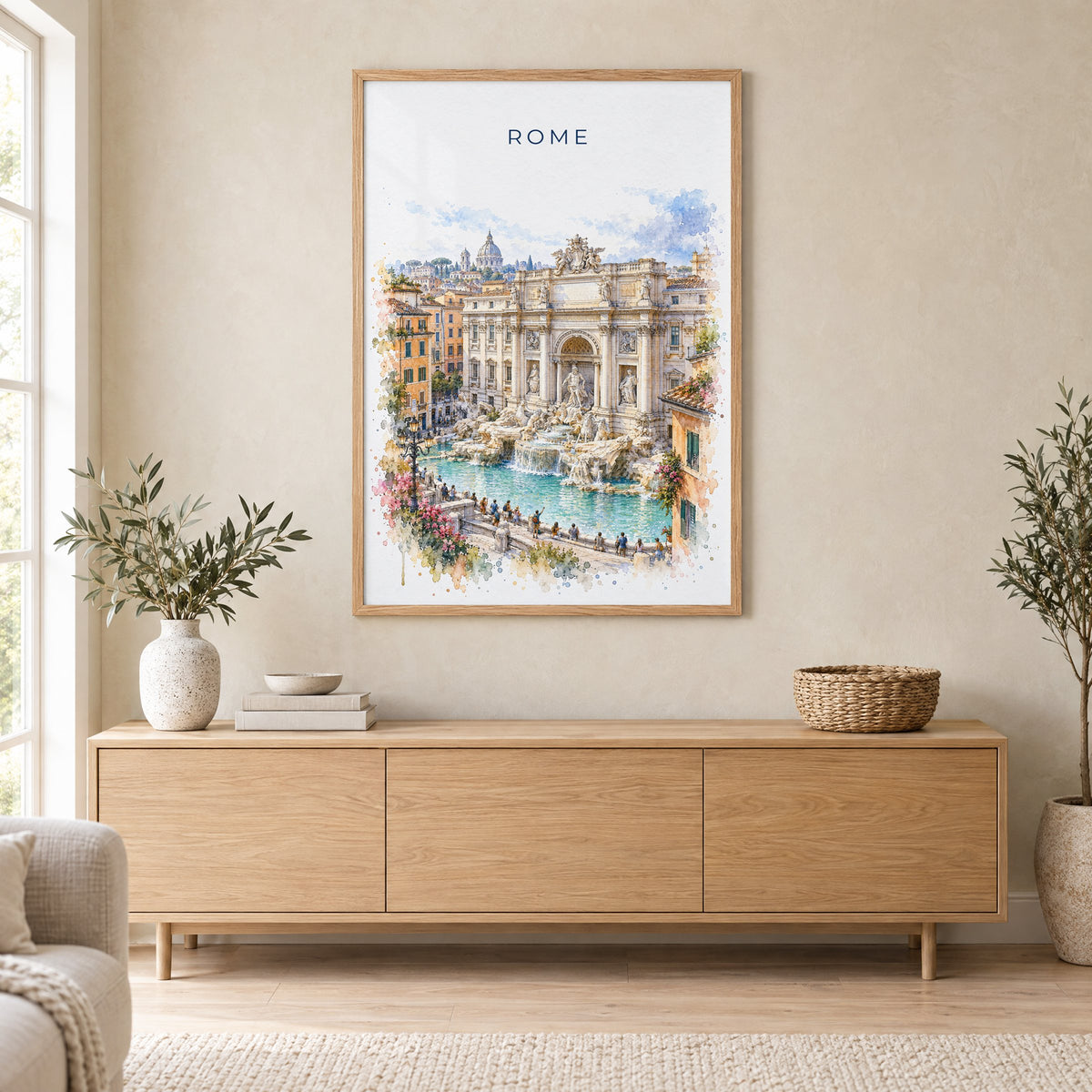 Trevi Fountain watercolor print in an oak frame above a light wood sideboard in a Scandinavian living room