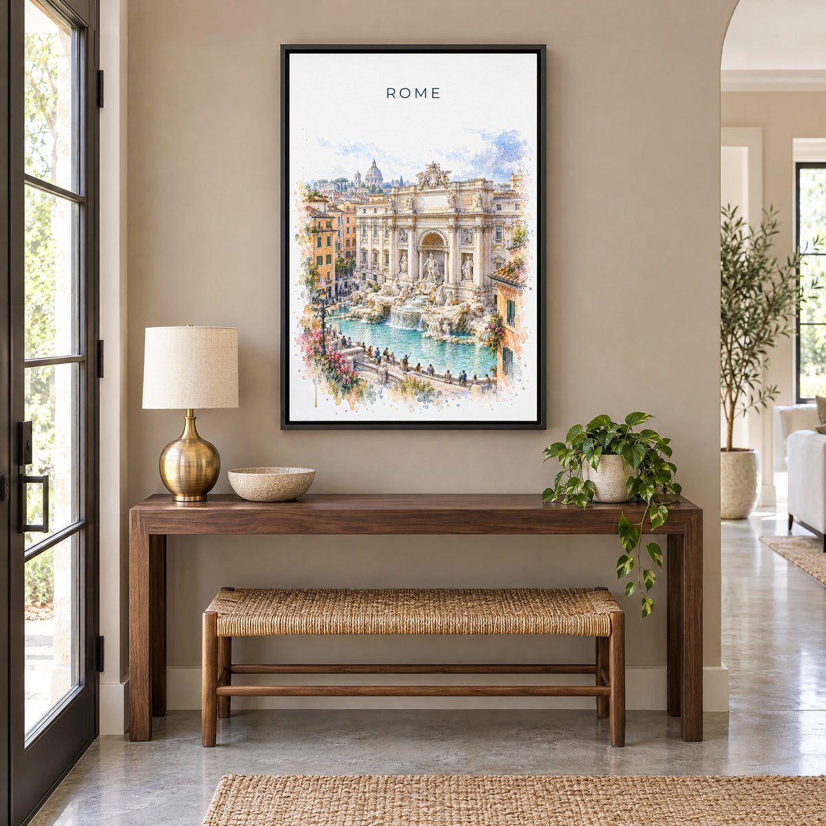 Trevi Fountain watercolor print as a black floater canvas above a walnut console and woven bench in an entryway