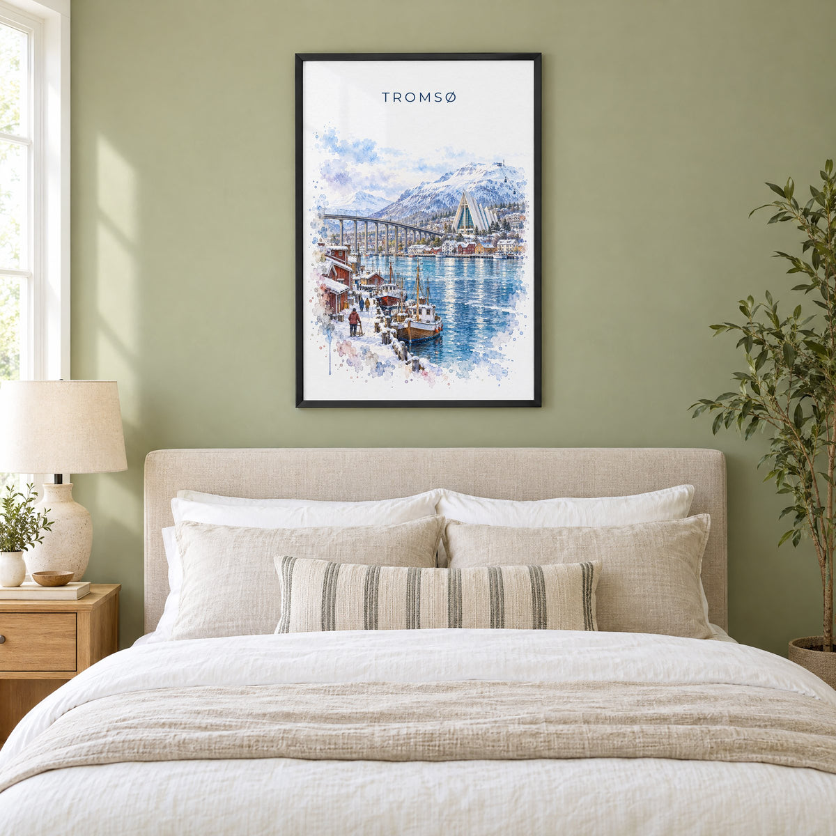 Tromsø, Norway watercolor print in a black frame above an upholstered headboard in a sage green bedroom