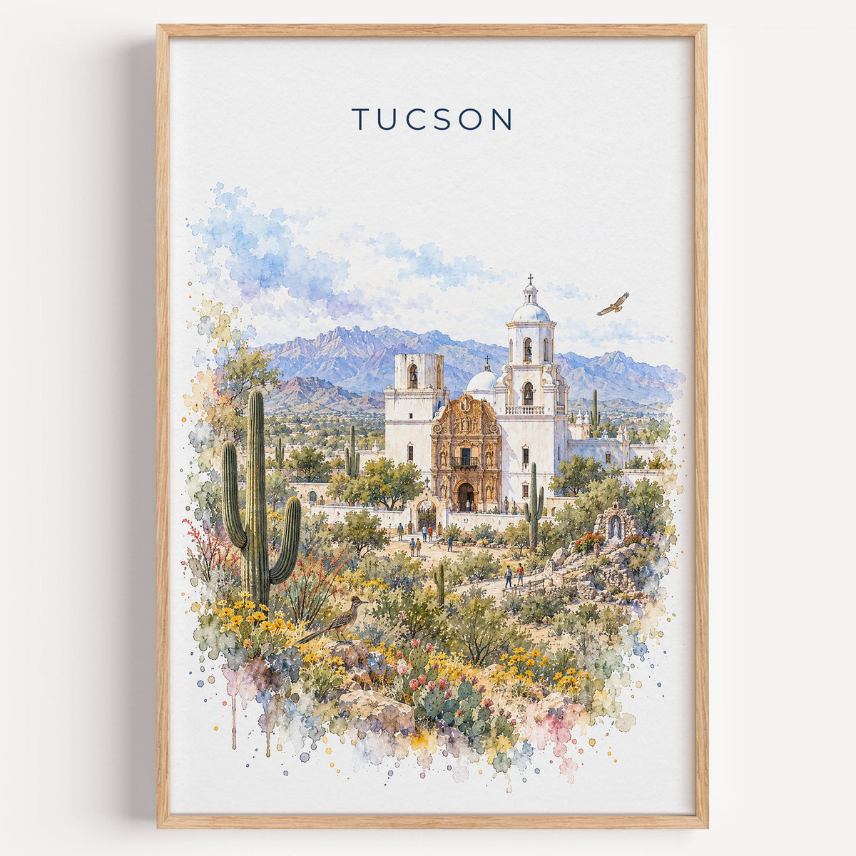 Tucson watercolor print in a light oak frame on a plain white wall