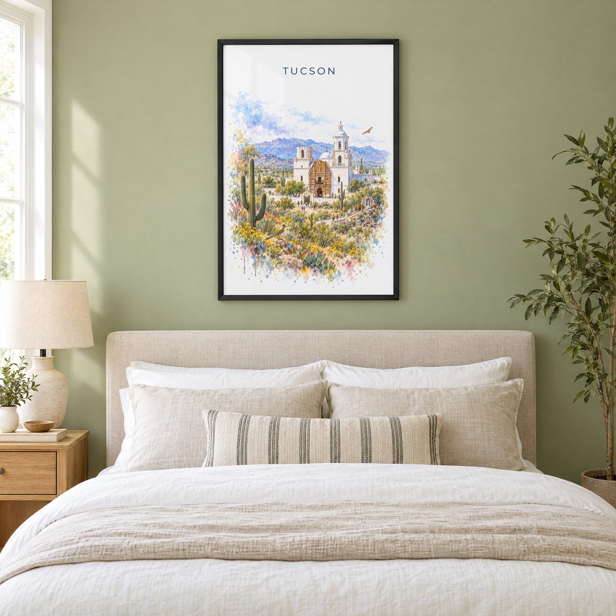 Tucson watercolor print in a black frame above an upholstered headboard in a sage green bedroom