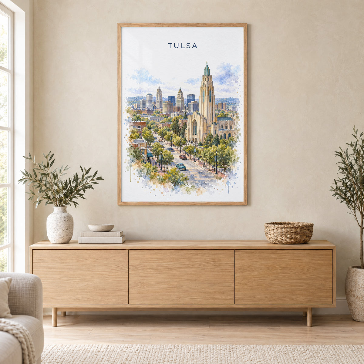 Tulsa watercolor print in an oak frame above a light wood sideboard in a Scandinavian living room