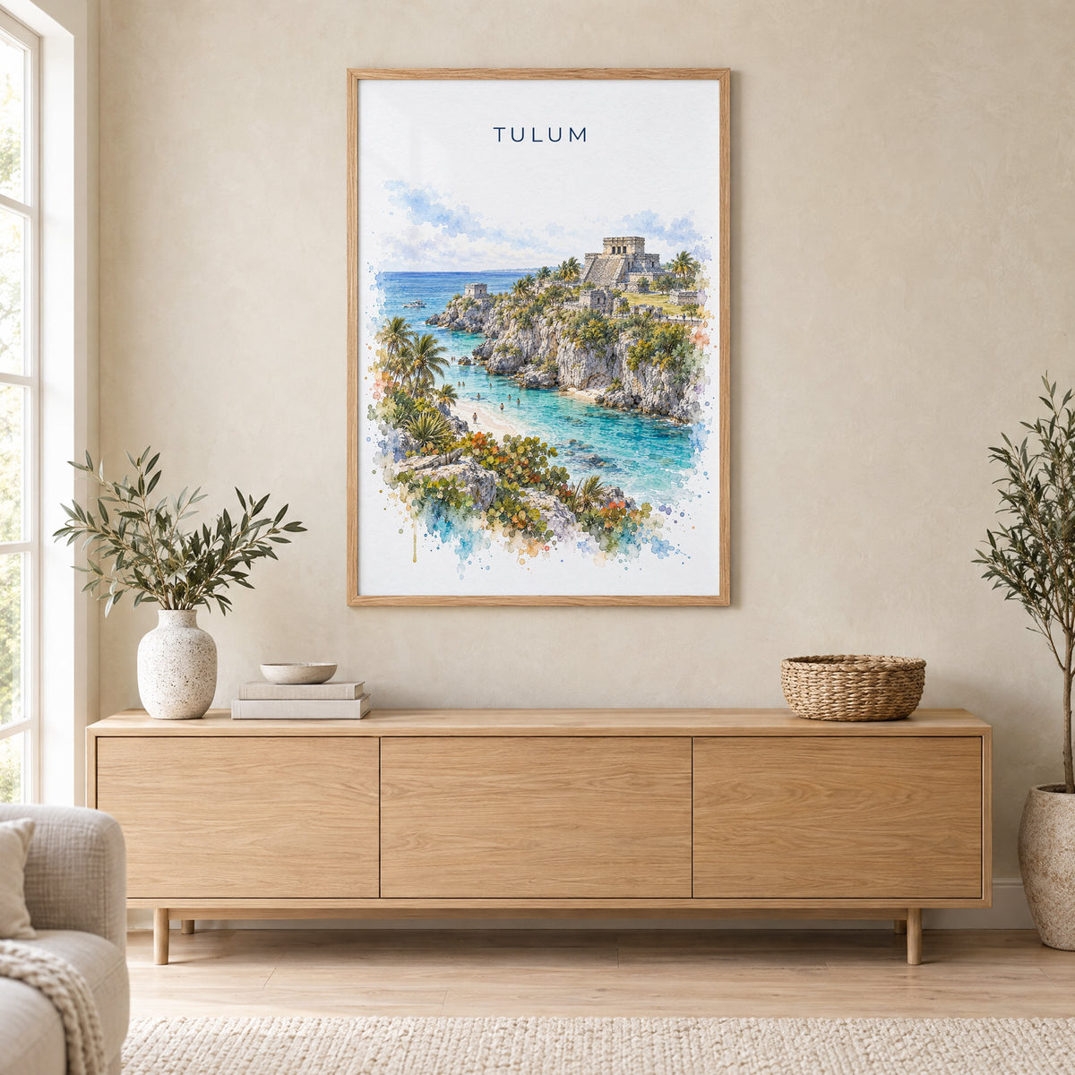 Tulum watercolor print in an oak frame above a light wood sideboard in a Scandinavian living room