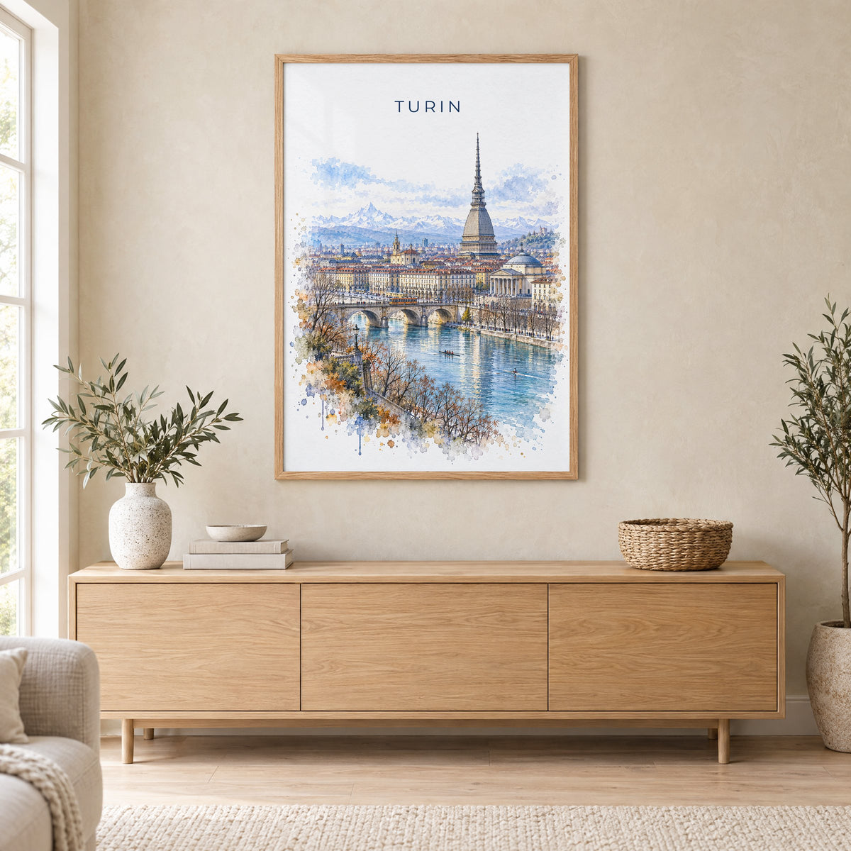 Turin watercolor print in an oak frame above a light wood sideboard in a Scandinavian living room