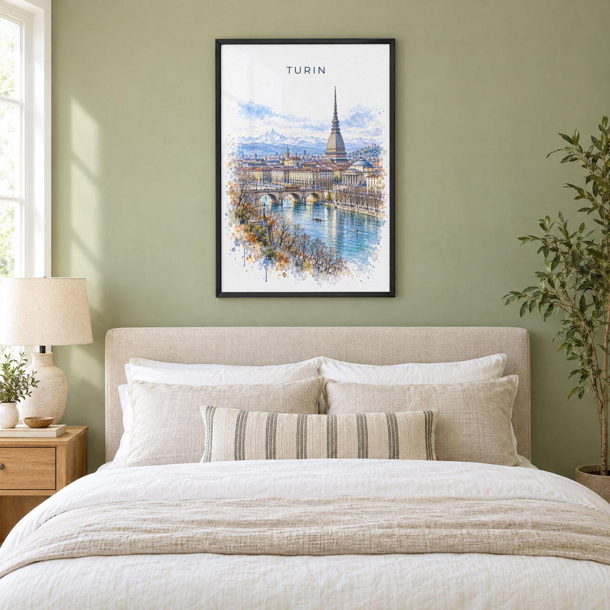 Turin watercolor print in a black frame above an upholstered headboard in a sage green bedroom