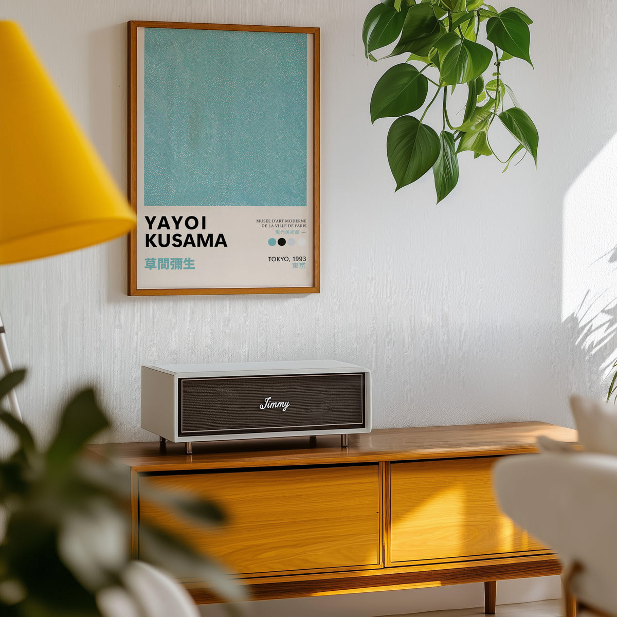 Yayoi Kusama inspired turquoise dotted texture print above a sideboard with a plant