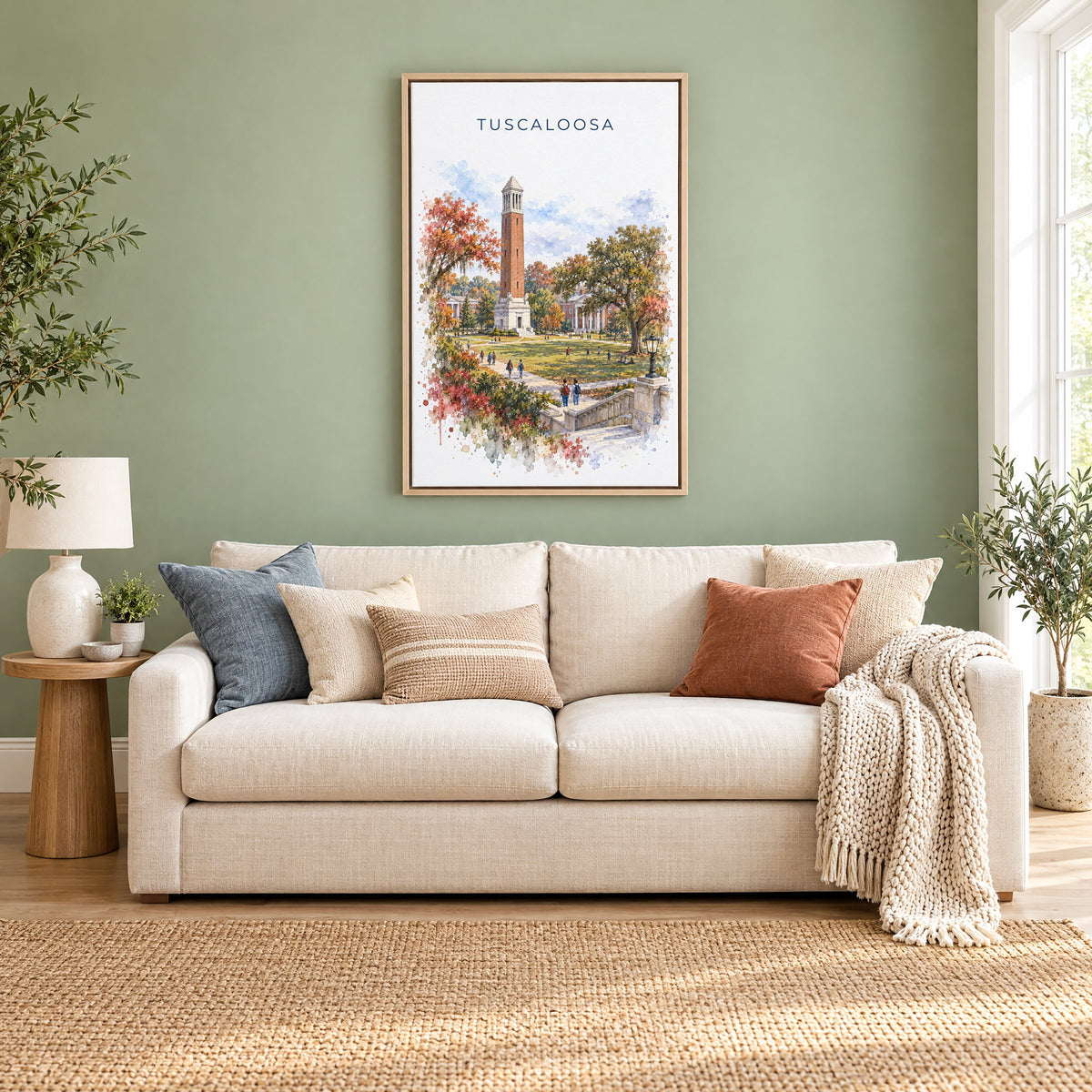 Tuscaloosa watercolor print as a natural floater canvas above a cream linen sofa on a sage green wall
