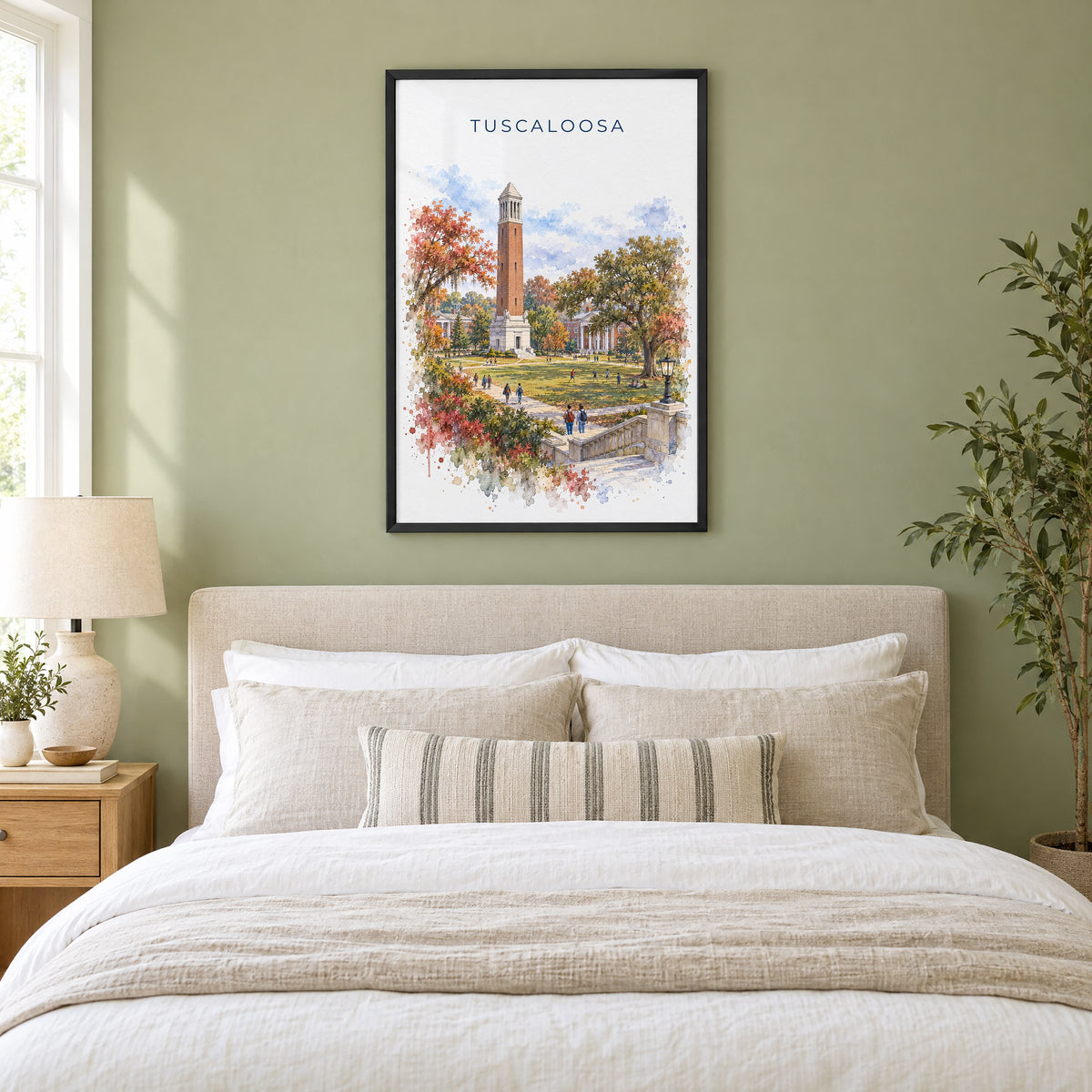Tuscaloosa watercolor print in a black frame above an upholstered headboard in a sage green bedroom