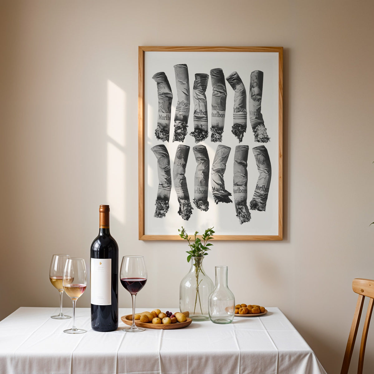 Twelve crushed cigarette ends in two rows print in an oak frame above a table set with red wine and glasses
