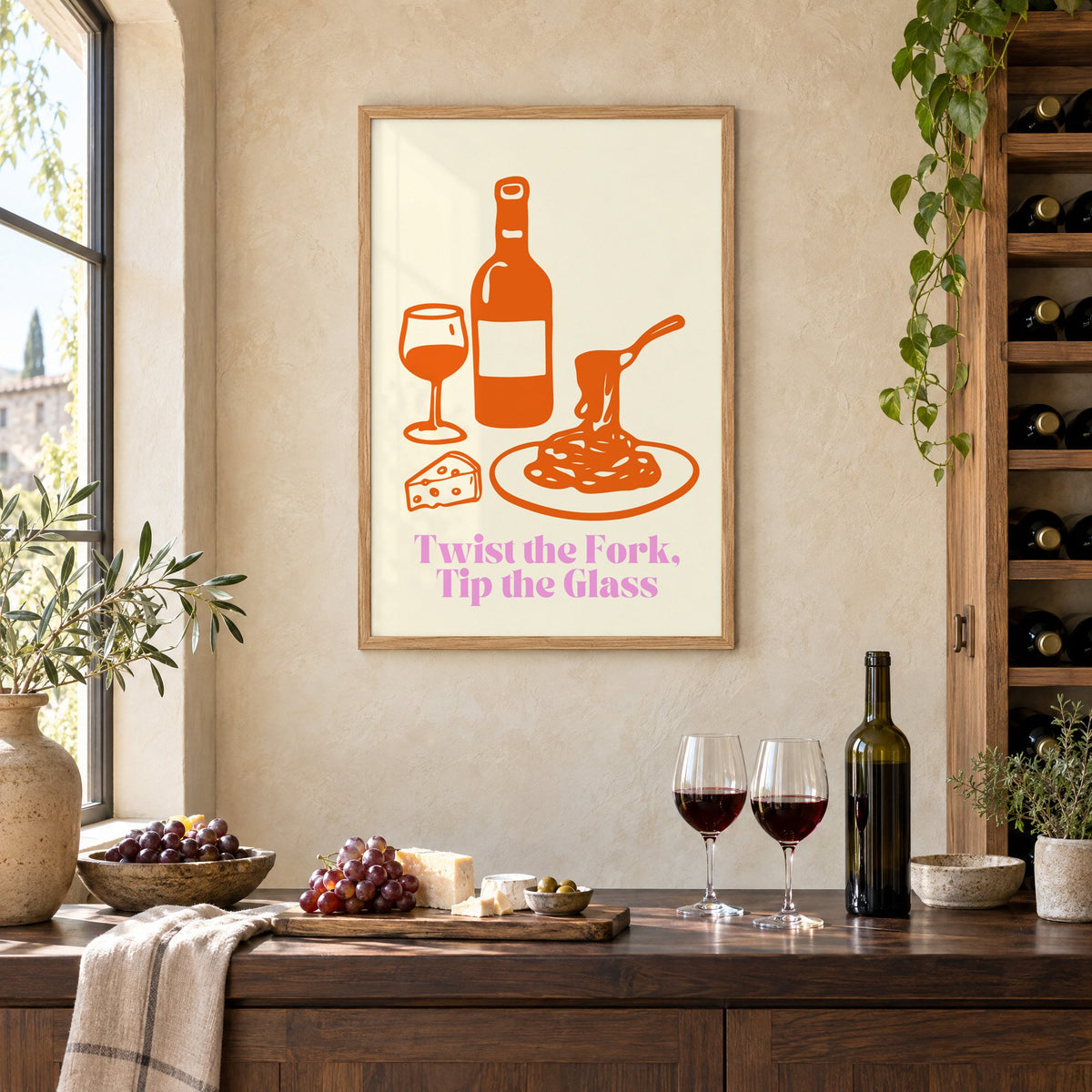 Twist the Fork, Tip the Glass wine and pasta print in an oak frame on a limewashed wall above a wine counter with red wine, cheese and grapes